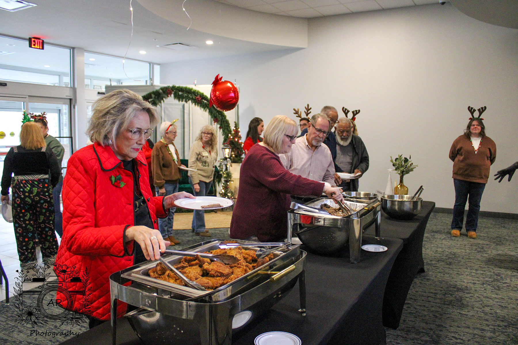 People serving themselves food at a Christmas party